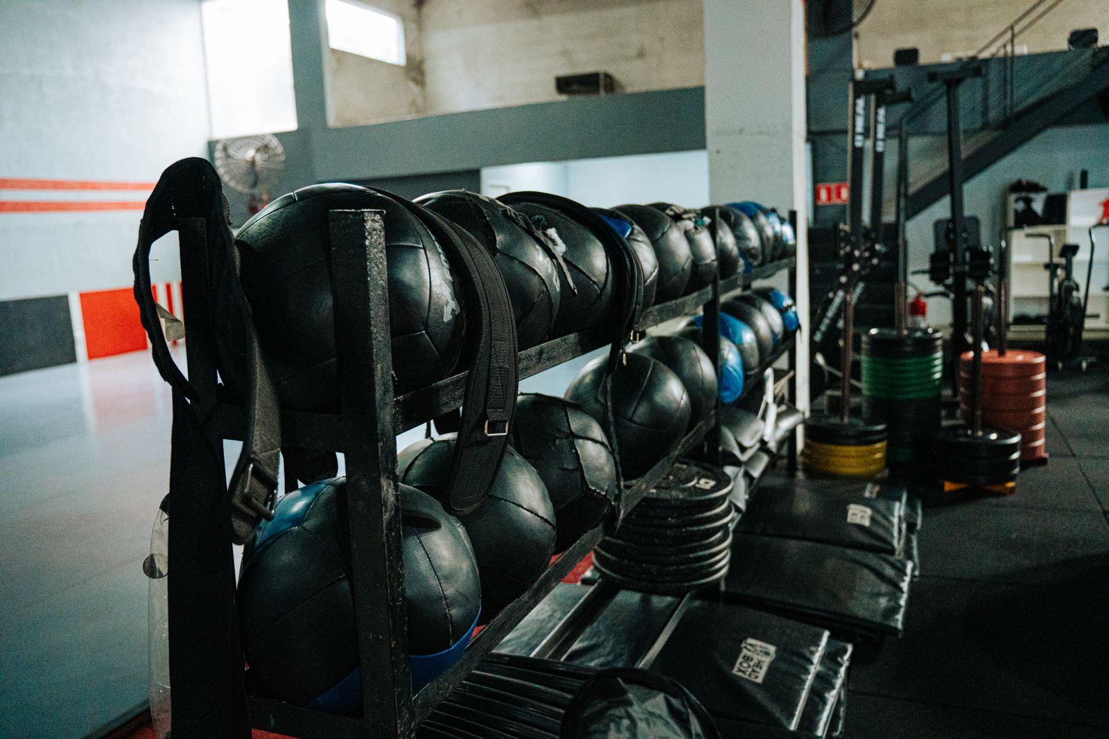 A rack of weighted training balls and plates in a training area